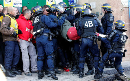 A prison warden is evacuated by French riot police as they block the Baumettes jail in Marseille during a nationwide protest, France, January 22, 2018. REUTERS/Jean-Paul Pelissier