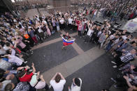 School graduates dance in the Palace Square as they take part the Scarlet Sails festivities marking school graduation in St. Petersburg, Russia, Friday, June 24, 2022. (AP Photo/Dmitri Lovetsky)