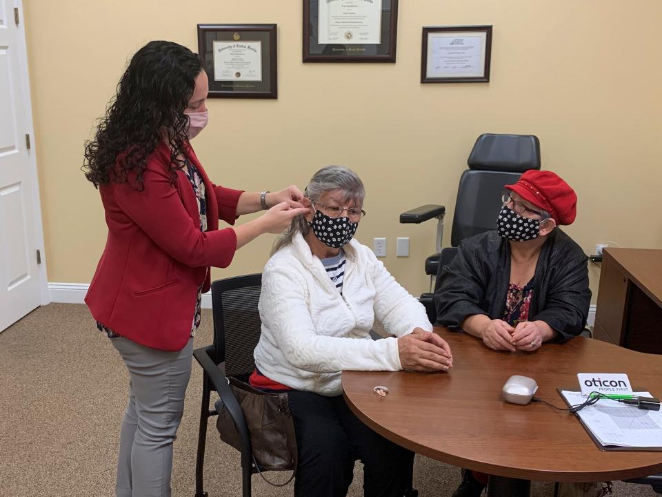 Dr. Kristen Weinbaum fits contest winner Marlene Arbelaez for her new hearing aids at Precision Hearing in Clermont.