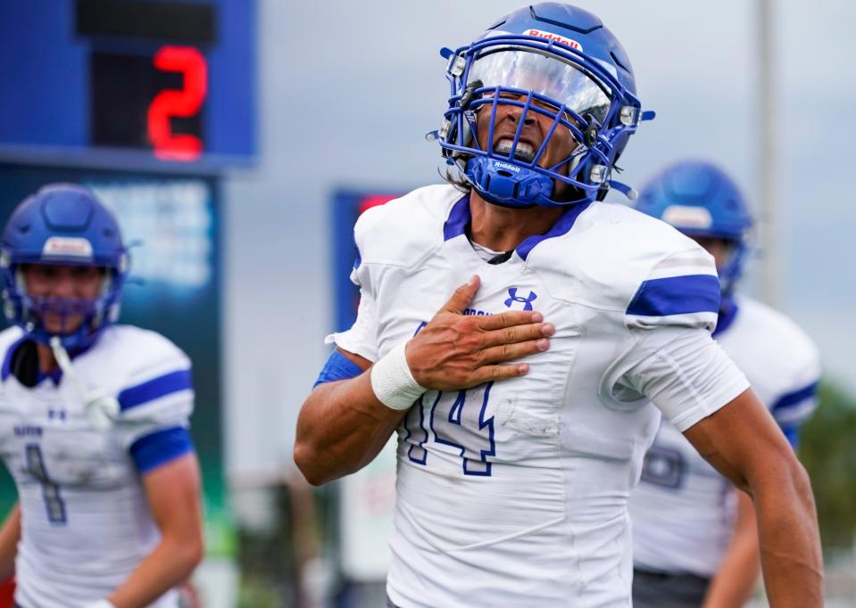 Barron Collier Cougars quarterback Niko Boyce (14) celebrates after scoring a rushing touchdown during the second quarter of a spring football game against the Southridge Spartans at Barron Collier High School in Naples on Wednesday, May 24, 2023.