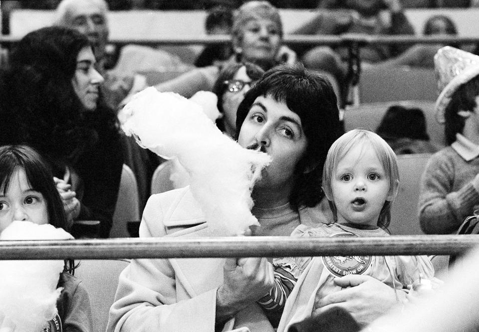 <p>Former Beatle Paul McCartney samples his young daughter Stella’s cotton candy as the two sit on the sidelines at New York’s Madison Square Garden, March 30, 1974, watching the Ringling Bros. & Barnum and Bailey Circus. (AP Photo/Suzanne Vlamis) </p>