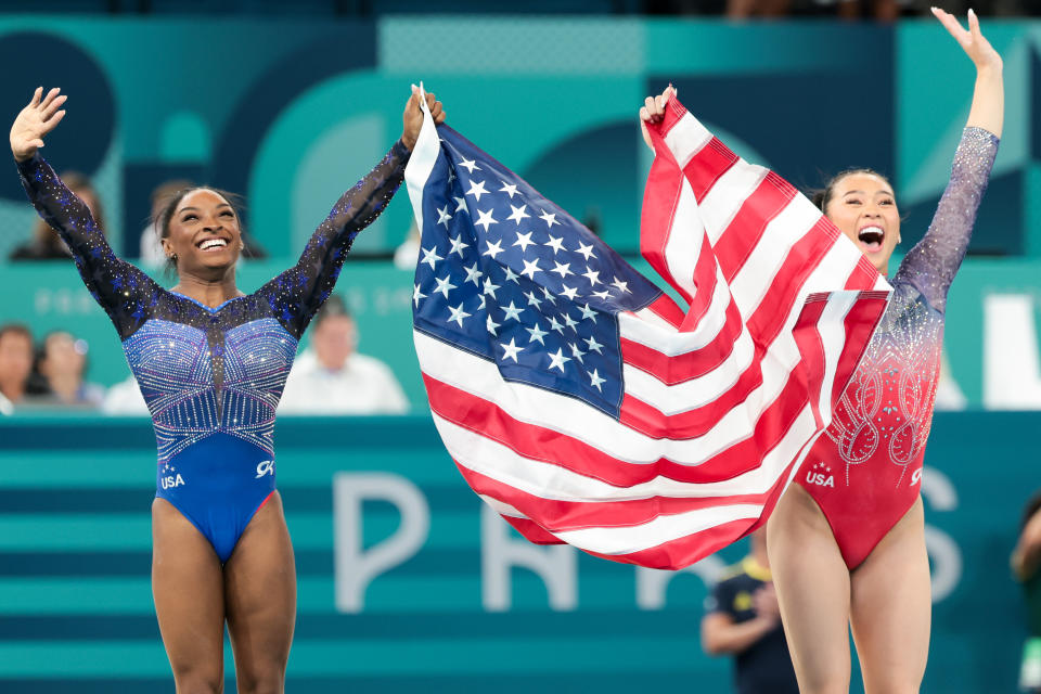 PARIS, FRANCE - AUGUST 01: Simone Biles, left, celebrates with Suni Lee after winning gold and bronze respectively during the womenOs all around gymnastic final at the 2024 Paris summer Olympics at Bercy Arena on Thursday, Aug. 1, 2024 in Paris, .(Wally Skalij / Los Angeles Times via Getty Images)