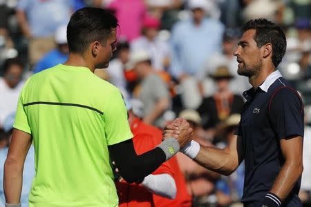 Milos Raonic (L) shakes hands with Jeremy Chardy (R) after their match on day eight of the Miami Open at Crandon Park Tennis Center. Raonic won 6-1, 5-7, 7-6 (3). Mandatory Credit: Geoff Burke-USA TODAY Sports