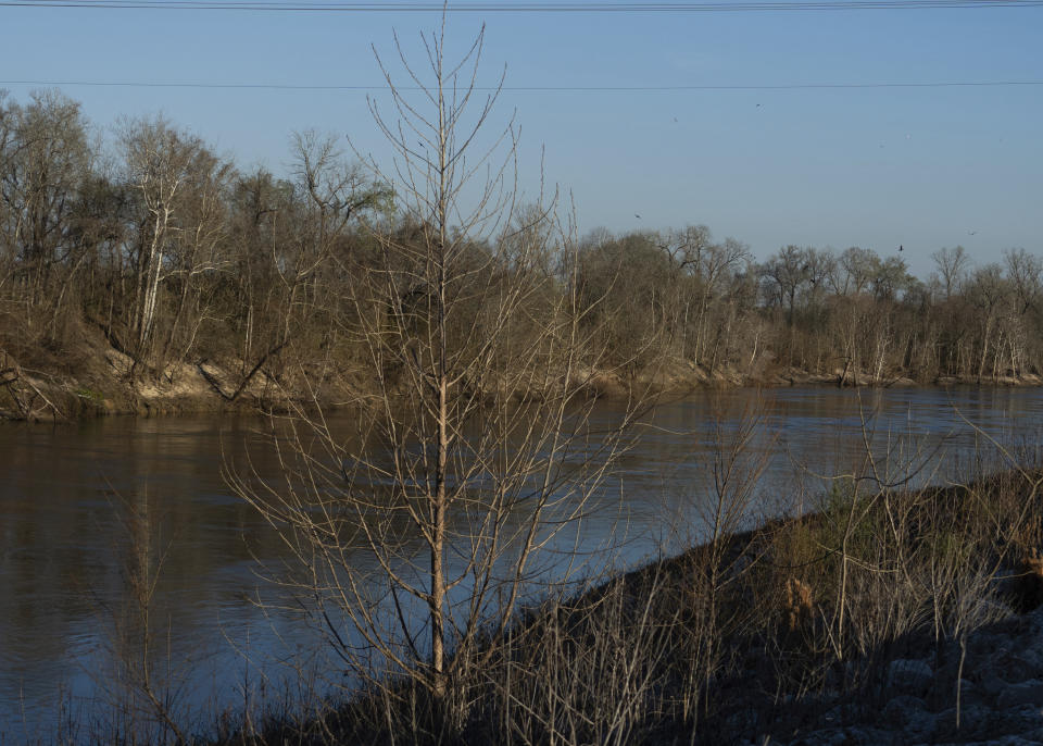 The Trinity River is seen near where law enforcement found the body of 11-year-old Audrii Cunningham, Tuesday, Feb. 20, 2024, in Livingston, Texas. Divers have recovered the body of Cunningham from the Texas river days after the girl went missing, and authorities are preparing to file a murder charge against a friend of her father who lived on her family’s property, a sheriff said Tuesday afternoon. (Jason Fochtman/Houston Chronicle via AP)