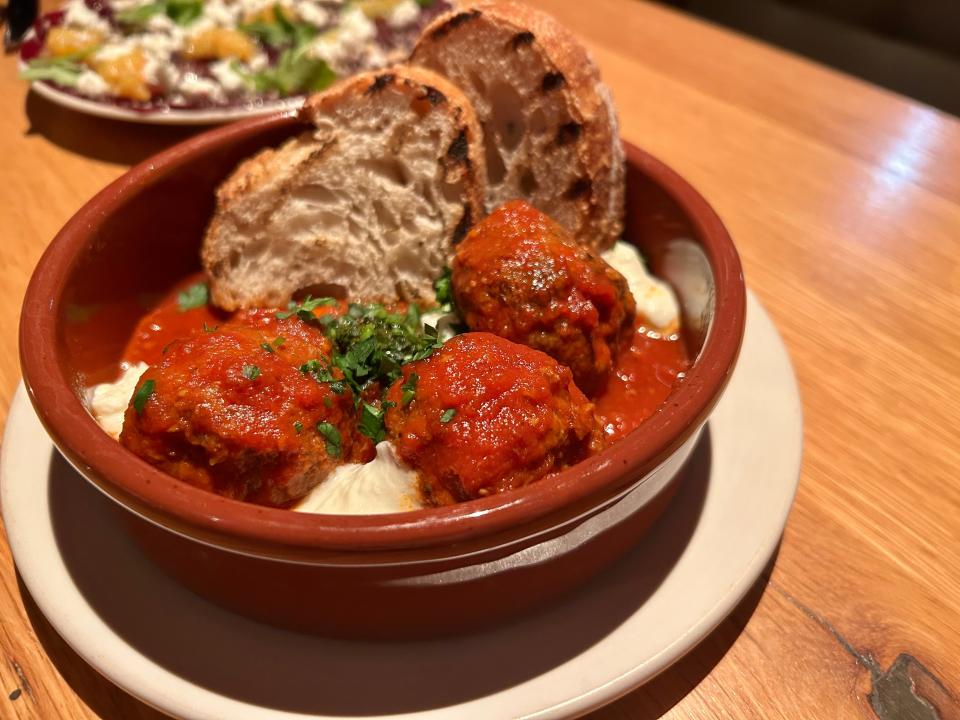 The meatballs in an appetizer at Tre Rivali in the Third Ward are served on a bed of tangy red sauce, fresh ricotta and pesto, with grilled bread on the side.