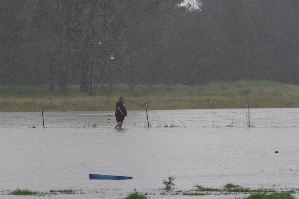 Farmers on Grange Road in Schofield tend to the stock due to heavy rain in Sydney on Saturday. Source: AAP