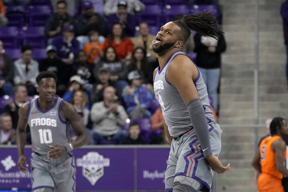 TCU center Eddie Lampkin Jr. (4) celebrates after sinking a three-point shot in the first half of an NCAA college basketball game against Oklahoma State, Saturday, Feb. 18, 2023, in Fort Worth, Texas. (AP Photo/Tony Gutierrez)