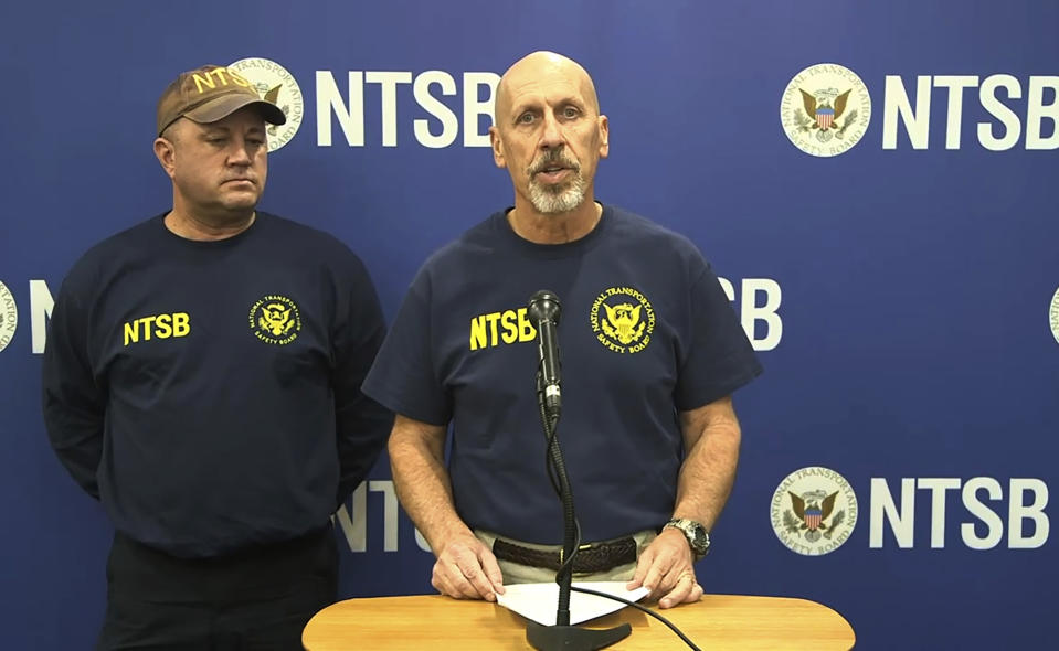 In this image taken from a National Transportation Safety Board video, Michael Graham of the NTSB, which is investigating a deadly helicopter crash that happened in Southern California's Mojave Desert speaks to the media in Barstow, Calif., Saturday, Feb. 10, 2024. The CEO of one of Nigeria's largest banks along with his wife and son were among those killed in Friday's crash. (National Transportation Safety Board via AP)