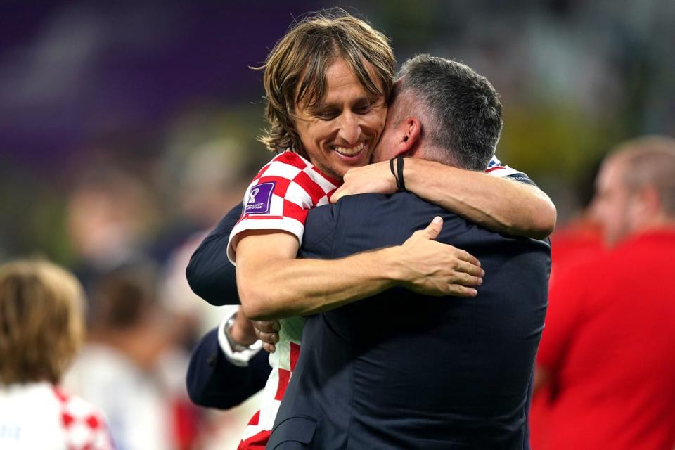 Luka Modric is hugged after Croatia beat Brazil (PA)