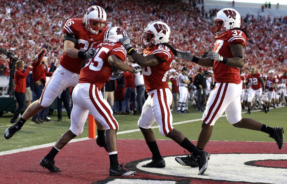 David Gilreath is swarmed by his teammates after running the opening kickoff back for a touchdown against Ohio State in 2010.