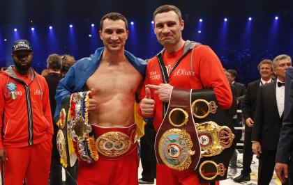 Wladimir Klitschko, left, celebrates with older brother Vitali after a win in April 2014. (AP)