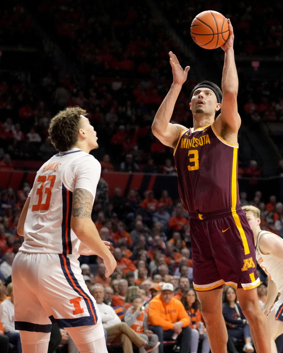 Minnesota' Dawson Garcia (3) scores as Illinois' Coleman Hawkins watches during the second half of an NCAA college basketball game Wednesday, Feb. 28, 2024, in Champaign, Ill. Illinois won 105-97. (AP Photo/Charles Rex Arbogast)