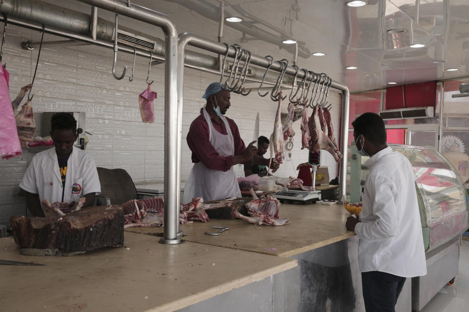 A man buys meat in Khartoum, Sudan, Wednesday, March.30, 2022. The UN has warned that more than 18 million people Sudanese, nearly half its population, could face severe hunger by this fall. (AP Photo/Marwan Ali)