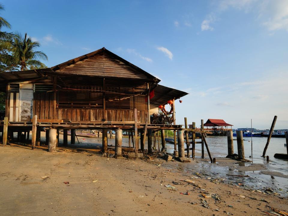 An old wooden house on stilts by the beach in Pulau Ubin, Singapore.