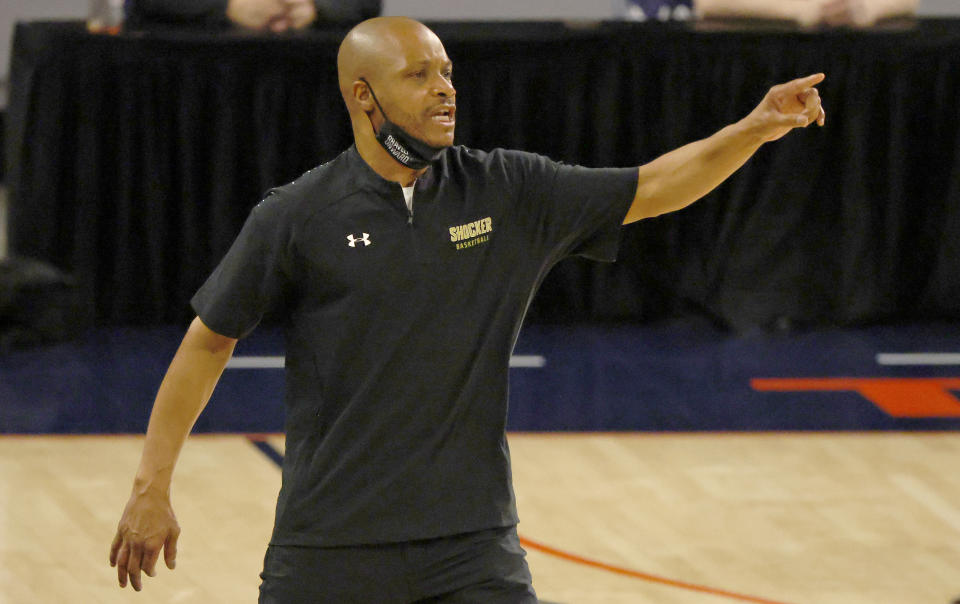 Wichita State head coach Isaac Brown calls a play as his team plays Cincinnati during the second half of an NCAA college basketball game in the semifinal round of the American Athletic Conference men's tournament Saturday, March 13, 2021, in Fort Worth, Texas. (AP Photo/Ron Jenkins)