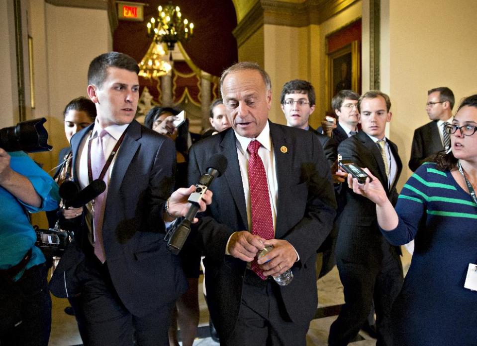 FILE - In this Oct. 15, 2013 file photo, Rep. Steve King, R-Iowa, walks from House Speaker John Boehner’s office with reporters in pursuit on Capitol Hill in Washington. King, a chief Republican foe of immigration legislation says it would be a “colossal mistake” for the House to consider any measure this year and shift attention from President Barack Obama’s health care law. (AP Photo/J. Scott Applewhite, File)