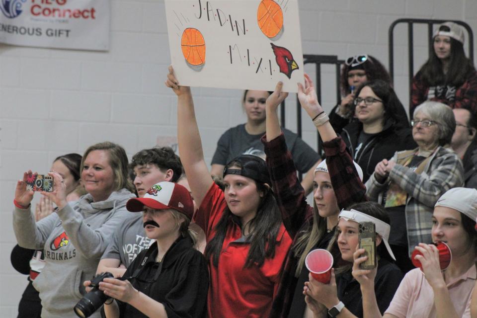 Onaway student supporters celebrate senior Jadin Mix reaching 1,000 points on Wednesday night.