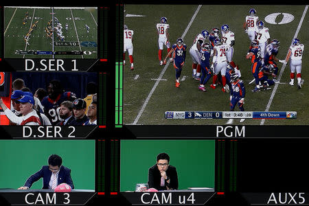 Screens show Chinese commentators Xiao Chen (bottom L) and Wang Zixing (bottom C) as they broadcast a livestream commentary of a NFL American football game in the control room of a studio of the media and gaming firm Tencent Holdings in Beijing, China, October 16, 2017. REUTERS/Thomas Peter