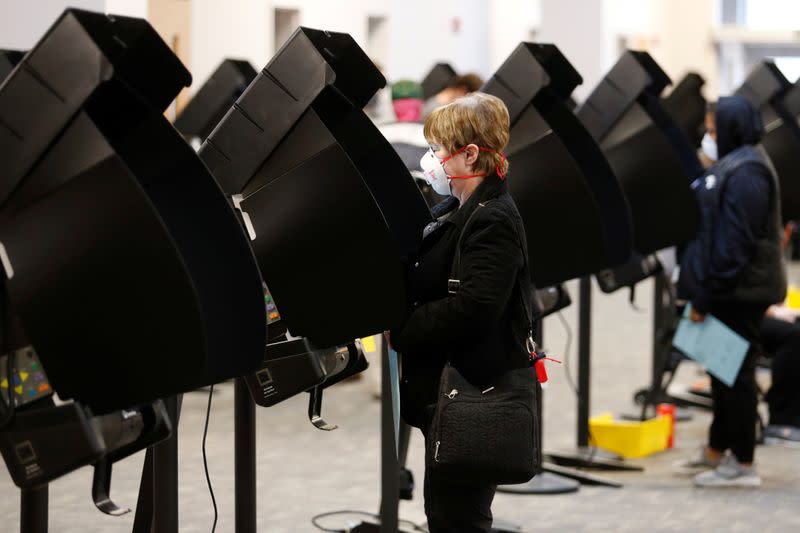 Voters line up to cast their ballots for the presidential primary elections in Columbus