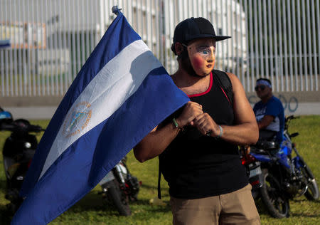 A masked protester holds a national flag during a protest against Nicaraguan President Daniel Ortega's government in Managua, Nicaragua May 16, 2018. REUTERS/Oswaldo Rivas