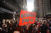 <p>Kelly Crowder, center, holds up a sign as thousands of protesters gather for the Women’s March against President Donald Trump Saturday, Jan. 21, 2017, in Los Angeles. The march is being held in solidarity with similar events taking place in Washington and around the nation. (AP Photo/Jae C. Hong) </p>