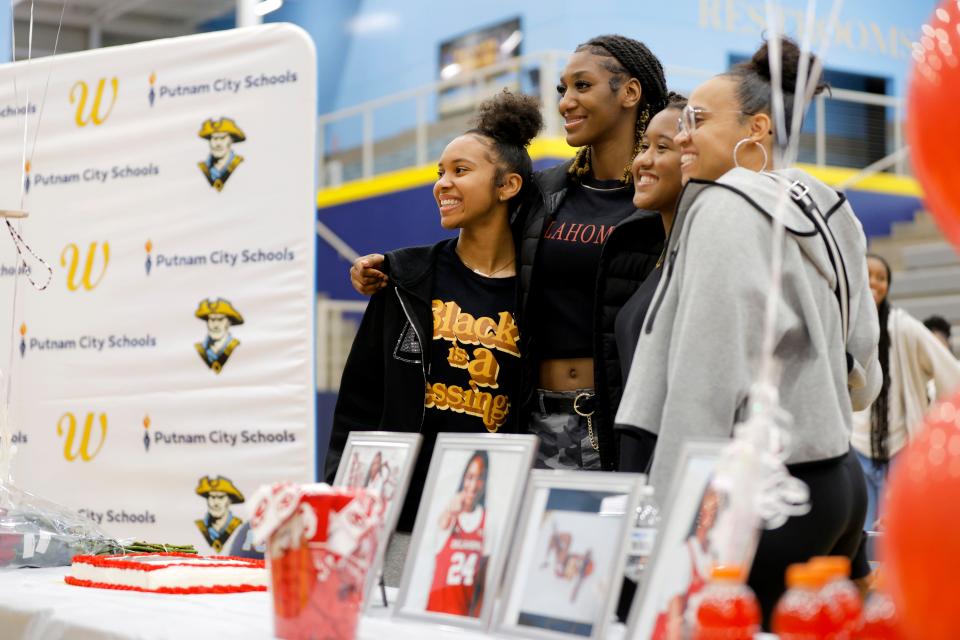 Putnam City West's Caya Smith, second from left, poses for a photo after announcing she is committing to the OU women's basketball team during a ceremony at PC West High School in Oklahoma City, Friday, Nov. 17, 2023.