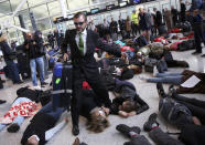 <p>Climate activist group Reclaim the Power lie on the ground and carry luggage during a protest against airport expansion plans at Heathrow Airport in London, Britain Oct. 1, 2016. (Photo: Neil Hall/Reuters)</p>