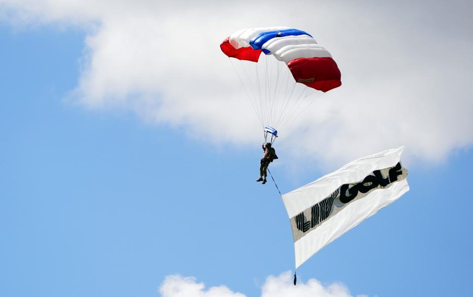 Oct 28, 2022; Miami, Florida, USA; A member of the Frog-X Navy SEAL Parachute Team skydives onto the course prior to the first round of the season finale of the LIV Golf series at Trump National Doral. Mandatory Credit: John David Mercer-USA TODAY Sports