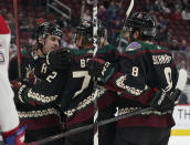 Arizona Coyotes' Clayton Keller (9) left, celebrates with Travis Boyd (72) and Nick Schmaltz (8) right, after Boyd's goal against the Montreal Canadiens during the first period of an NHL hockey game Monday, Jan. 17, 2022, in Glendale, Ariz. (AP Photo/Darryl Webb)