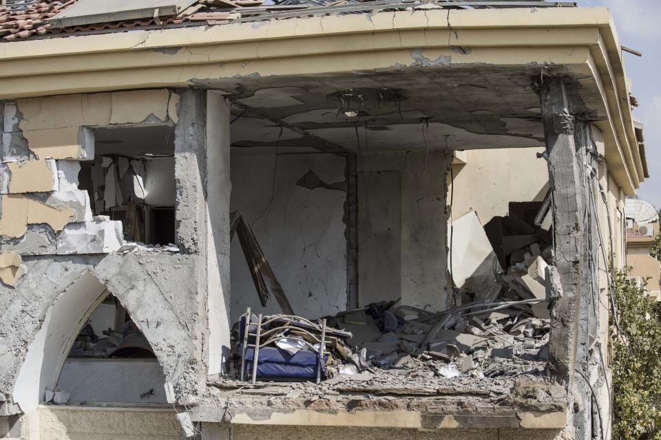 A damage to the house that was hit by a missile fired from Gaza Strip, is seen in the city of Beersheba, southern Israel, Wednesday, Oct. 17, 2018. A medical service said a woman and her three children, whose home was struck, were being treated for shock after they fled to their shelter upon being awoken by warning sirens. (AP Photo/Tsafrir Abayov)