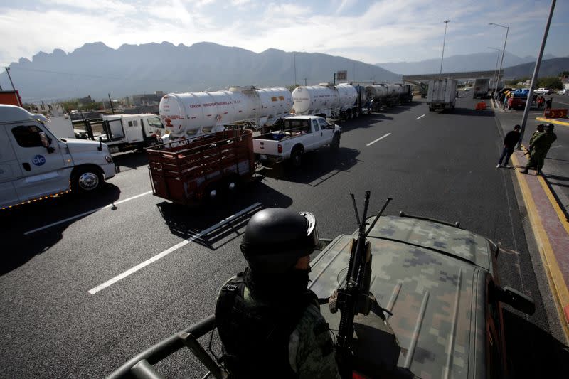 Members of the Mexican National Guard keep watch at a highway during the 12th Caravan of Migrants in Sabinas Hidalgo