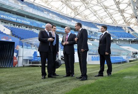 Russian President Vladimir Putin (C) and FIFA President Gianni Infantino (L) visit the Fisht Stadium, which will host matches of the 2018 FIFA World Cup in Sochi, Russia May 3, 2018. Sputnik/Aleksey Nikolskyi/Kremlin via REUTERS