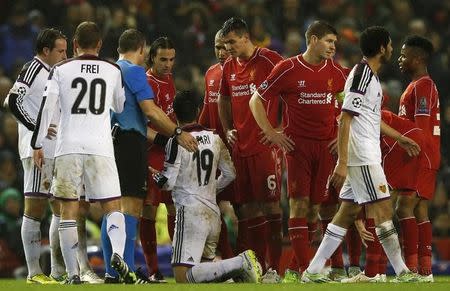 Liverpool's Lazar Markovic (4th L) looks at FC Basel's Behrang Safari (5th L) after being sent off during their Champions League Group B soccer match at Anfield in Liverpool, northern England, December 9, 2014. REUTERS/Phil Noble