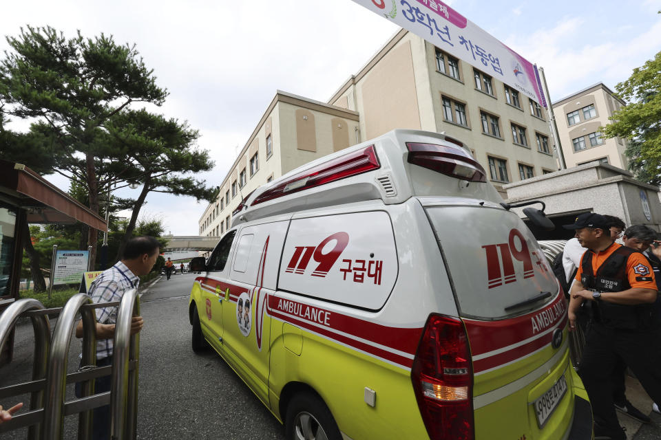 An ambulance enters Songchon High School in Daejeon, South Korea, Friday, Aug. 4, 2023. South Korean police are chasing the suspect in a stabbing attack at the high school in the central city of Daejeon, a day after another stabbing incident at a shopping mall in the city of Seongnam, south of Seoul, leaving multiple people wounded. (Kim Jun-beom/Yonhap via AP)