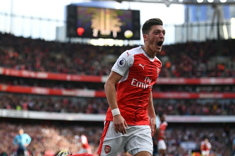 Arsenal's Mesut Ozil celebrates after scoring a goal during their English Premier League match against Swansea City, at the Emirates Stadium in London, on October 15, 2016