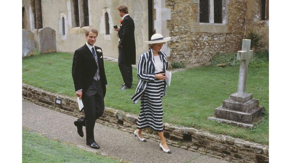 Princess Diana in a blue and white striped skirt suit with her brother-in-law Prince Edward