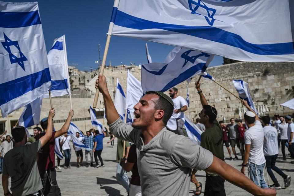 Israelis wave the national flag at the Western Wall in Jerusalem’s Old City (AFP via Getty Images)