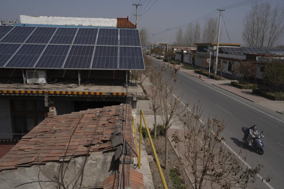 Solar panels sit on the rooftop of a house in the rural outskirts of Jinan in eastern China's Shandong province on March 21, 2024. China is the runaway leader in supplying the world with the hardware to gather solar power. Now it's pushing to install more at home, and it’s working so well that the grid now has more power than it can handle. (AP Photo/Ng Han Guan)
