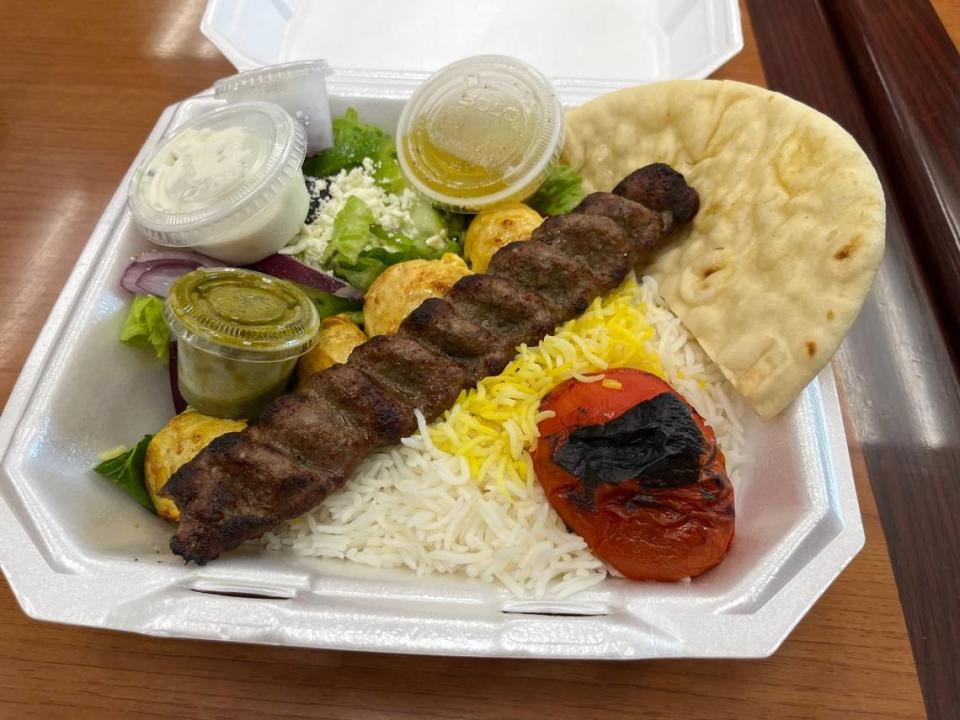 The Mixed Kabob plate at Athens Pizza & Kabob comes with one skewer of koobideh and one skewer of chicken, along with Greek salad, pita, rice and a grilled tomato.