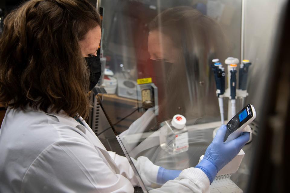 Laura Stevens, a senior research specialist, works in a lab at Vanderbilt University Medical Center on Oct. 8. Stevens was involved in the development of the new antiviral drug, molnupiravir, that can reduce the risk of COVID-19 hospitalizations and deaths.