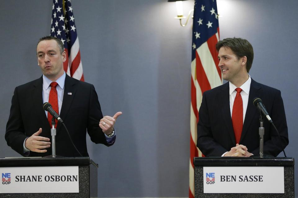 In this March 11, 2014 photo GOP-backed Senate candidate Shane Osborn, left, and tea-party backed Ben Sasse, right, debate in Omaha, Neb. During the debate Osborn pledged “to support whoever wins” the four-way primary on May 13. But make no mistake, Nebraska is a new front in the bitter national struggle inside the Republican Party between established leaders determined to maintain control and right-wing insurgents trying to change the party’s direction. (AP Photo/Nati Harnik)