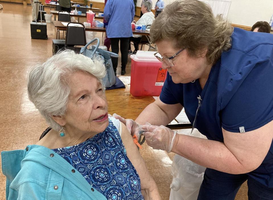 Mildred Schultz, a 90-year-old Erie resident, receives a dose of flu vaccine Friday during LECOM Health's kickoff vaccination clinic at Zem Zem Shrine, 2525 W. 38th St.