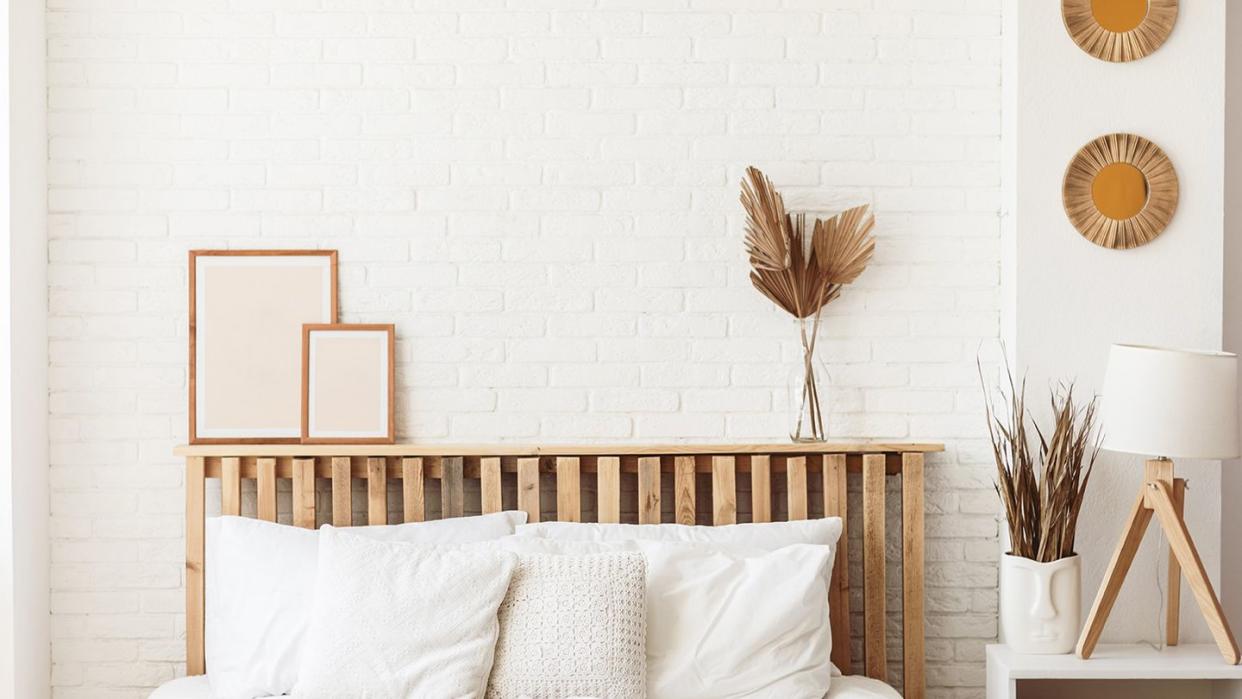diy headboard with white bedding and rustic decor