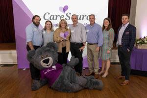 CareSource Foundation NWFL Grant Challenge with The Family Cafe
: Top Recipient, The Family Café,
with Director, Community Engagement at CareSource, Ellen Miller and VP of Regional Business
Development at CareSource, Adam Beam on the right along with Cuddles the CareSource bear posing.