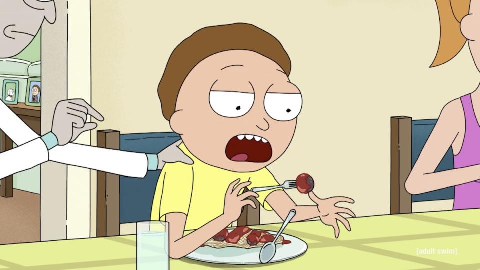 Morty drops his fork of spaghetti and meatballs as Rick grabs his shoulder