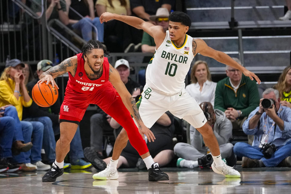 Houston guard Emanuel Sharp, left, attacks as Baylor guard RayJ Dennis defends during the first half of an NCAA college basketball game, Saturday, Feb. 24, 2024 in Waco, Texas. (AP Photo/Julio Cortez)