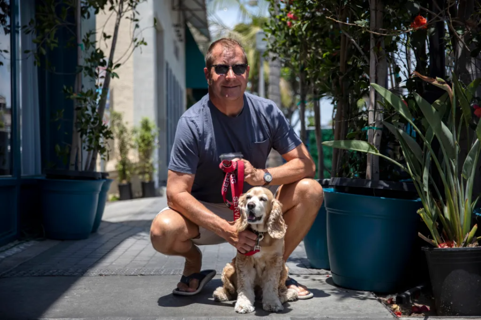 Manhattan Beach resident David Sulaski, who supports cannabis shops opening, is pictured with his dog Stella in Manhattan Beach on May 27, 2022.