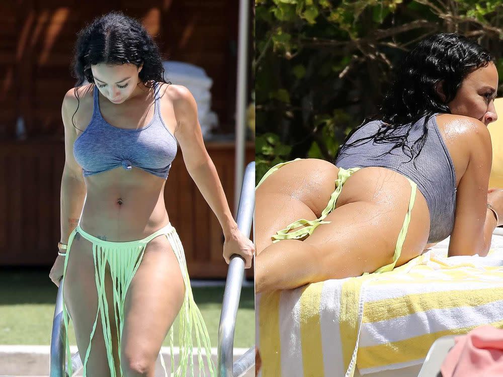 Draya Michele sunbathes in bikini bottoms and a rolled-up tank top