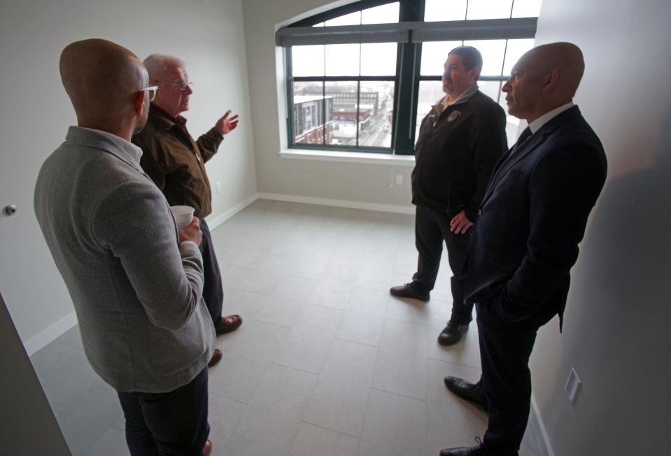 Nelson Fernandes of the Downtown Brockton Association, ZBA Chair Kenneth Galligan, Commissioner of Buildings James Plouffe and City Councilor David C. Teixeira discuss the renovations of the "Furniture Building" at 93 Centre St. and the apartments that were officially open to the public on Tuesday, March 26, 2024.