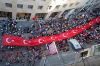 Supporters of Turkish President Tayyip Erdogan carry a huge Turkish flag during a pre-election gathering in Istanbul, Turkey, June 20, 2018. REUTERS/Huseyin Aldemir